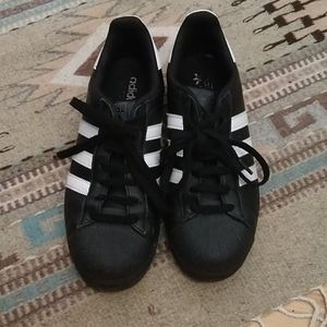 Black and white adidas superstars